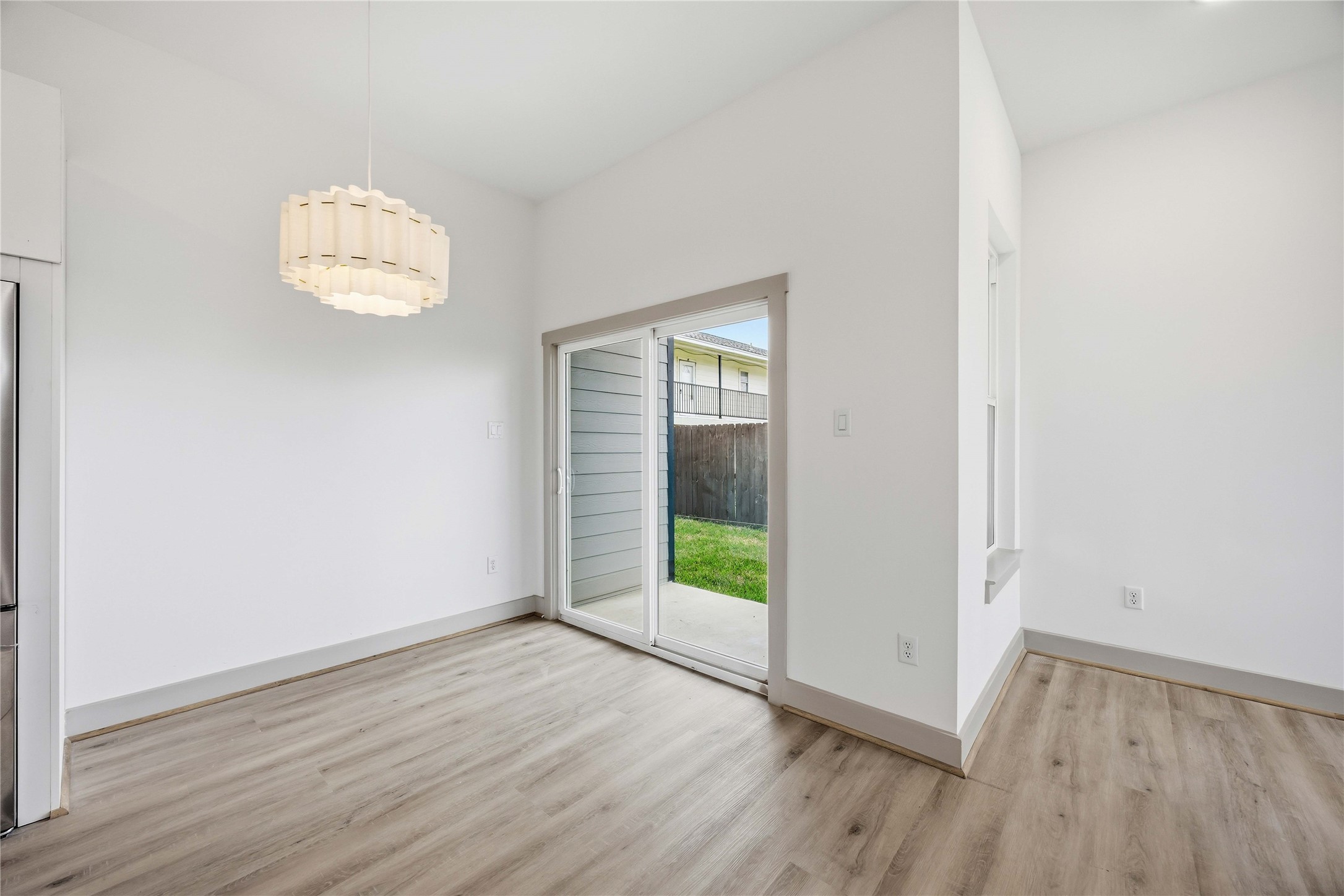 7555 Calhoun Road, Unit A/B Houston, TX 77033 - Photo 10 of 27 an empty room with wooden floor and windows