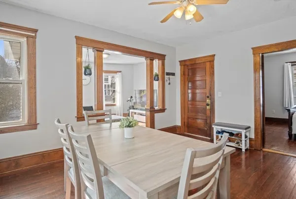 a view of a dining room with furniture and wooden floor