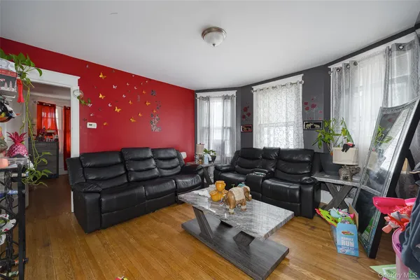 a living room with furniture window and wooden floor