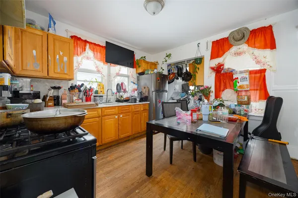 a room with stainless steel appliances kitchen island granite countertop furniture and a sink
