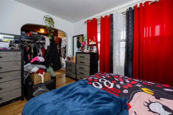 a bedroom with a bed closet and a closet