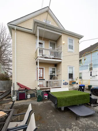 a view of a house with a yard porch and sitting area