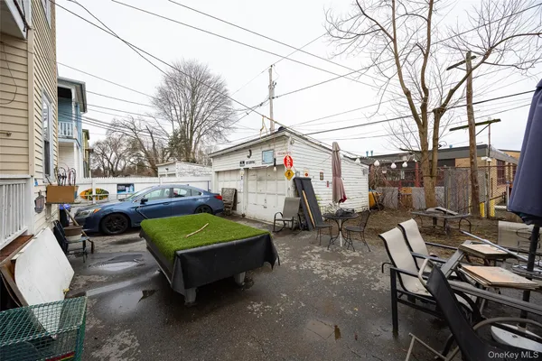 a view of a patio with table and chairs with wooden fence and plants