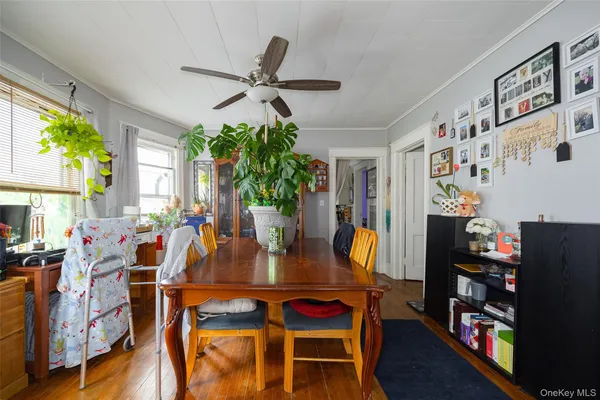 a view of a dining room with furniture and a potted plant