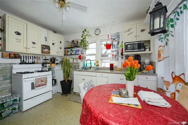 a kitchen that has a lot of cabinets a sink and a stove