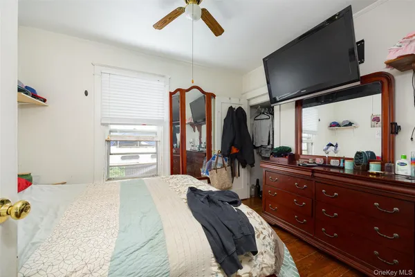 a bedroom with furniture and a flat screen tv
