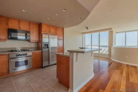 a kitchen with stainless steel appliances granite countertop a refrigerator a stove top oven a sink and dishwasher