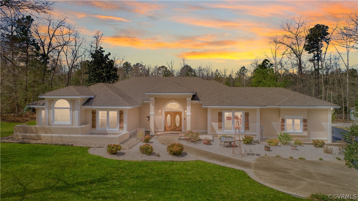 a front view of a house with garden and porch
