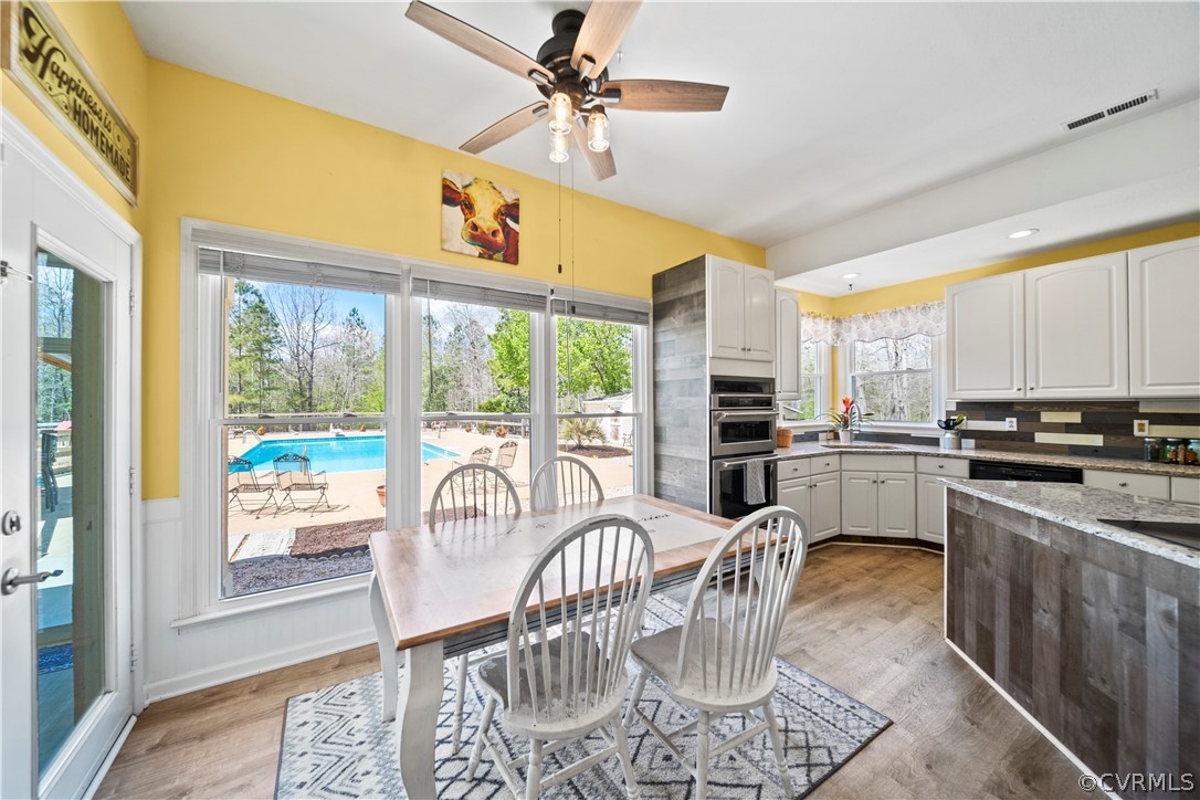 12700 Coalboro Road Chesterfield, VA 23838 - Photo 20 of 50 a kitchen with a table chairs stove and cabinets
