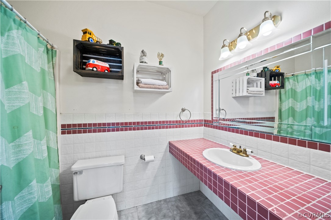 12700 Coalboro Road Chesterfield, VA 23838 - Photo 35 of 50 a bathroom with a sink a toilet and a shower curtain