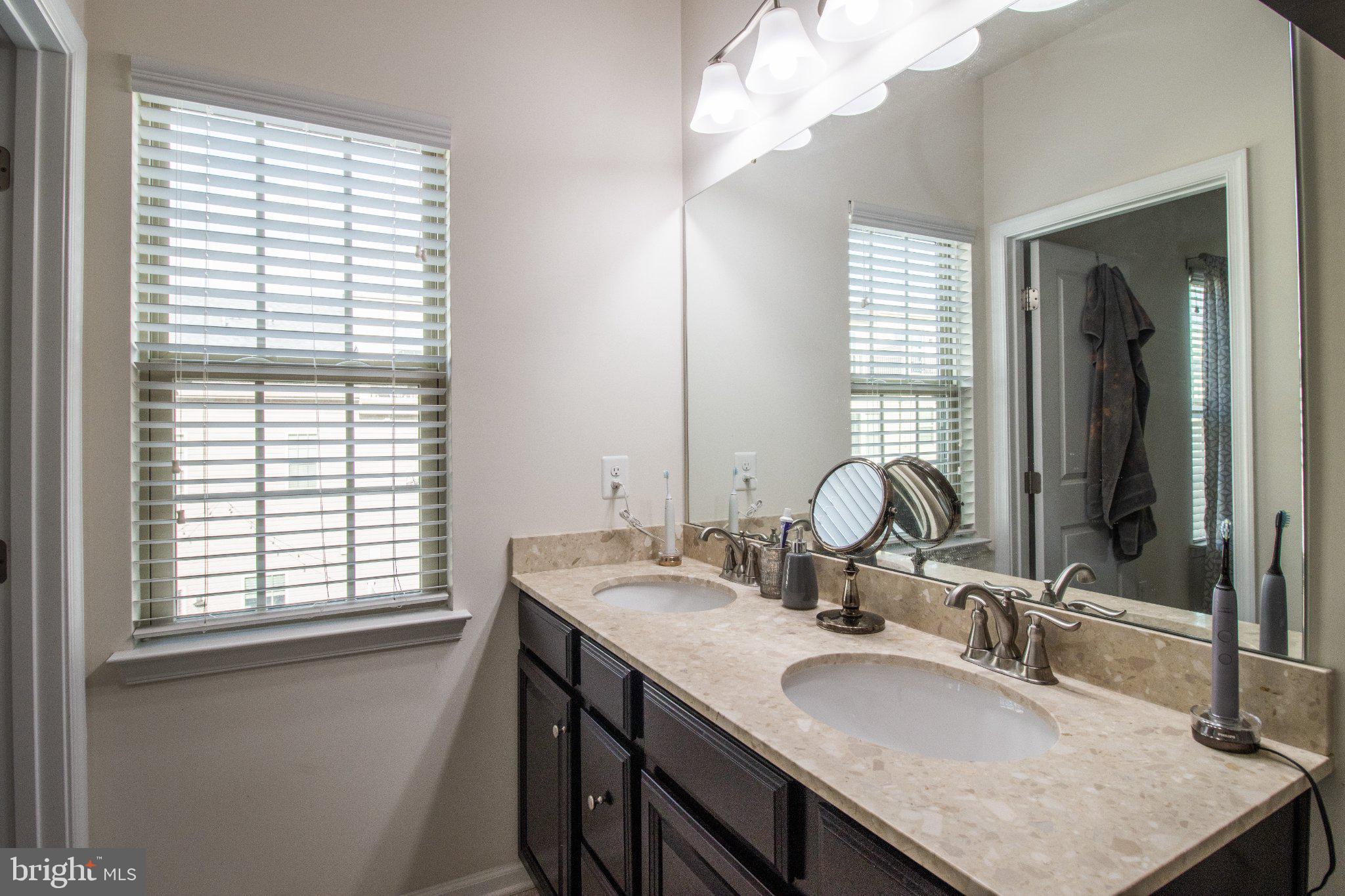 4658 Hudson Street Baltimore, MD 21224 - Photo 32 of 35 Bright and airy dual-sink bathroom.