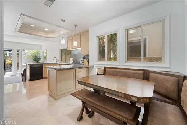 a kitchen with a table chairs sink and window