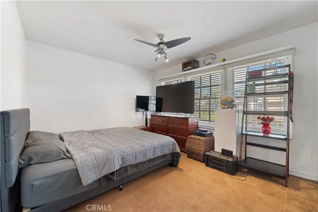 a bed sitting in a bedroom next to a window