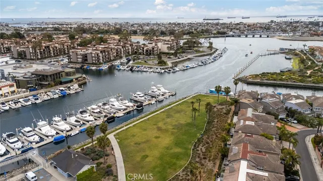 an aerial view of a residential houses with outdoor space and parking
