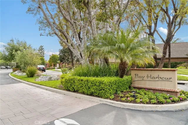 a front view of a house with a garden and plants