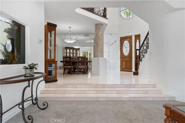 a view of a hallway with couch and mirror