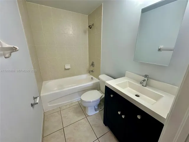 a bathroom with a toilet a sink and bathtub