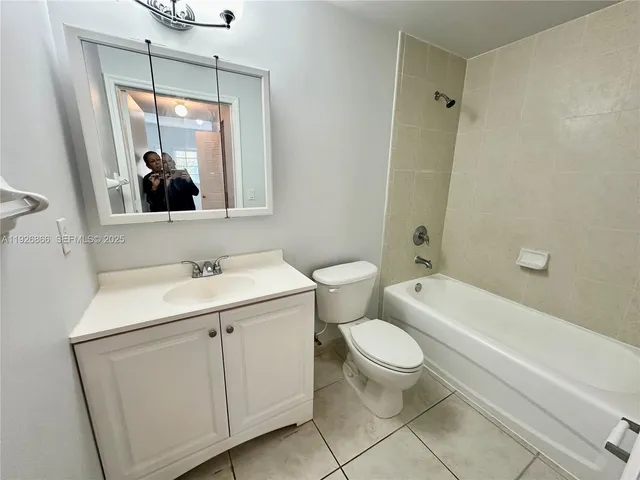 a bathroom with a sink toilet vanity and tub