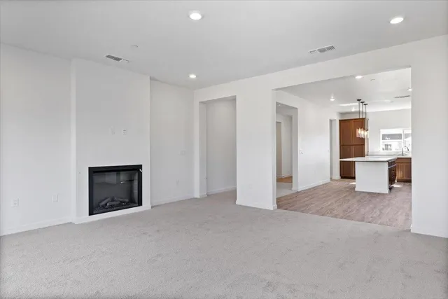 a view of an empty room with a fireplace