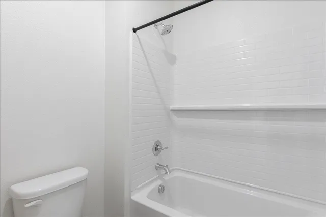a bathroom with a shower and a toilet