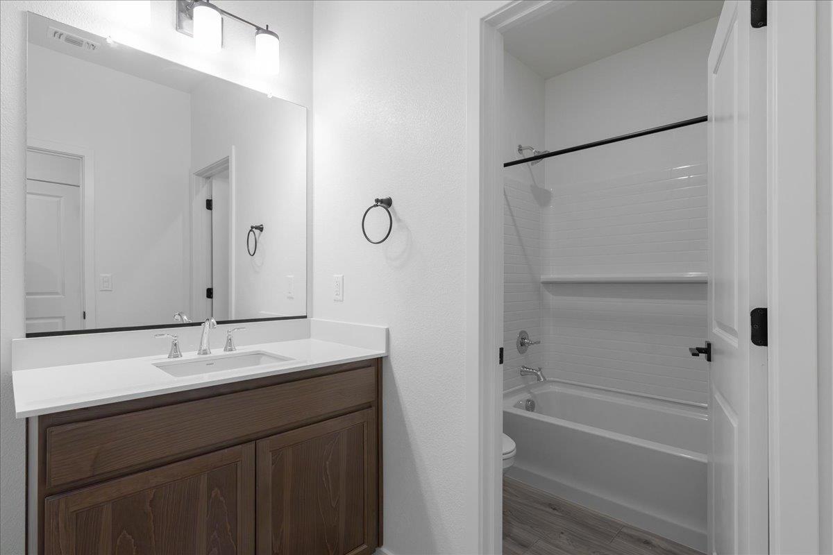 284 Piper Lane Colusa, CA 95932 - Photo 33 of 37 a bathroom with a granite countertop sink a mirror and a bathtub