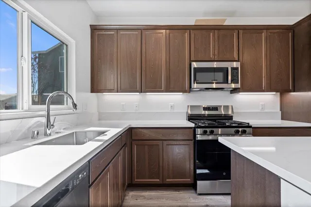 a kitchen with a sink stove and microwave