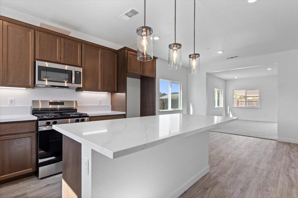 284 Piper Lane Colusa, CA 95932 - Photo 7 of 37 a kitchen with kitchen island a sink stainless steel appliances and cabinets