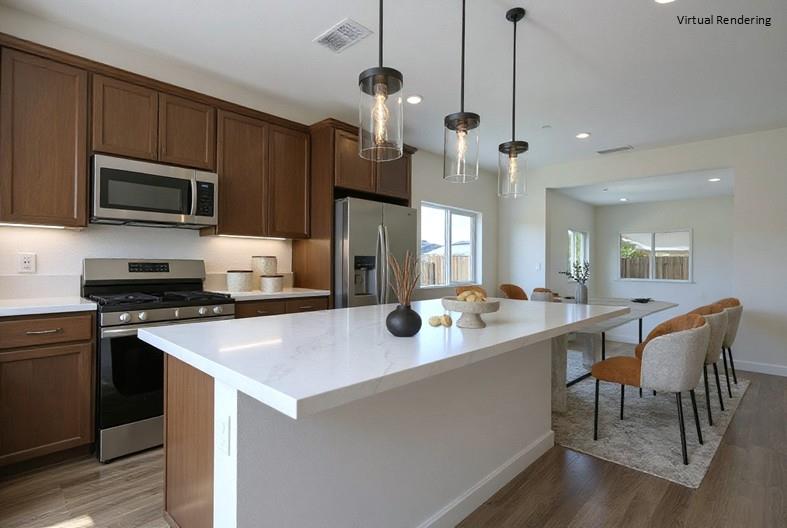 284 Piper Lane Colusa, CA 95932 - Photo 8 of 37 a kitchen with stainless steel appliances a stove refrigerator a microwave oven a sink a dining table and chairs