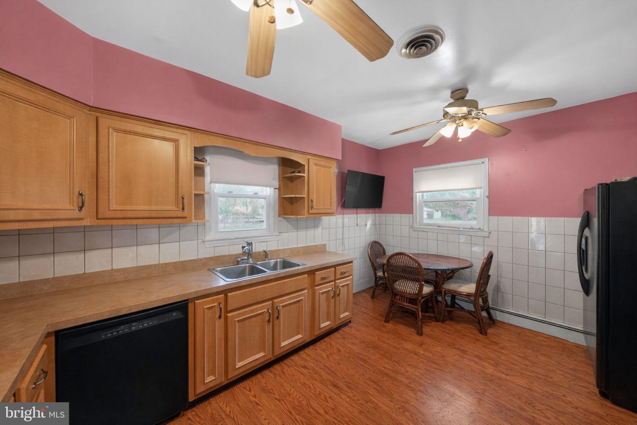 10509 North Keys Road Brandywine, MD 20613 - Photo 7 of 30 a kitchen with a sink cabinets and wooden floor