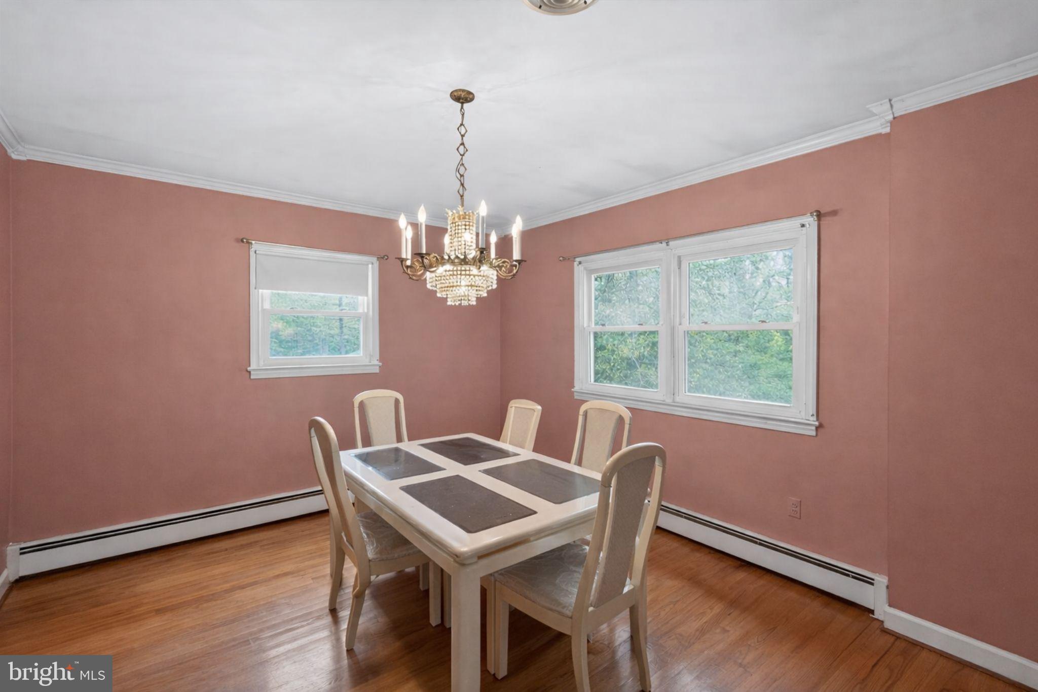 10509 North Keys Road Brandywine, MD 20613 - Photo 8 of 30 a view of a dining room with furniture a chandelier and wooden floor