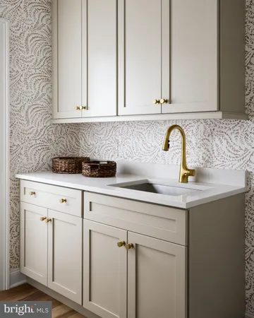 a close view of a sink a mirror and cabinets