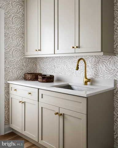 a close view of a sink a mirror and cabinets