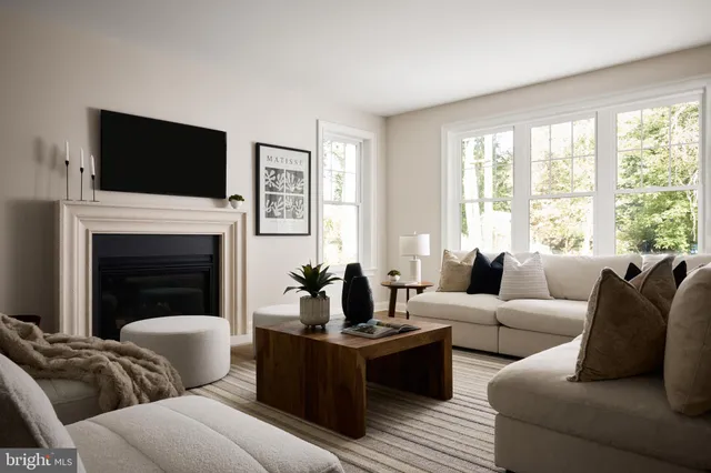 a living room with furniture fireplace and flat screen tv