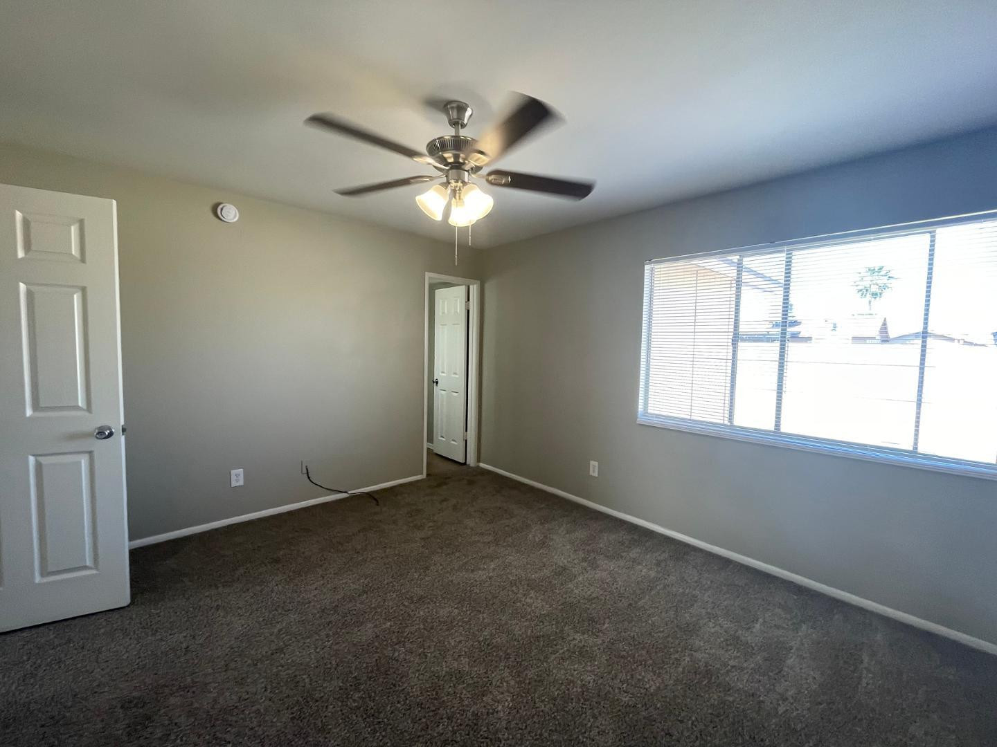 10902 West Montecito Avenue Phoenix, AZ 85037 - Photo 12 of 22 an empty room with windows and fan