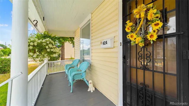 a balcony with table and chairs