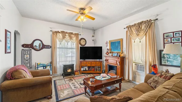 a living room with fireplace furniture and a flat screen tv