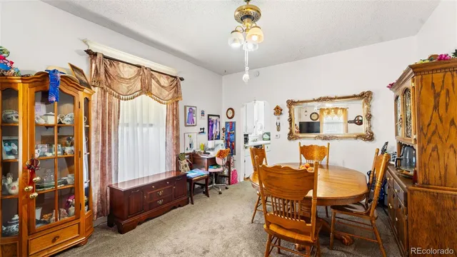 a dining room with furniture and a chandelier