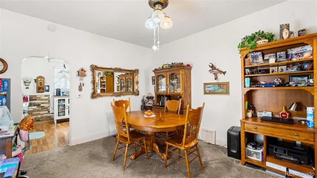 a view of a dining room with furniture and chandelier
