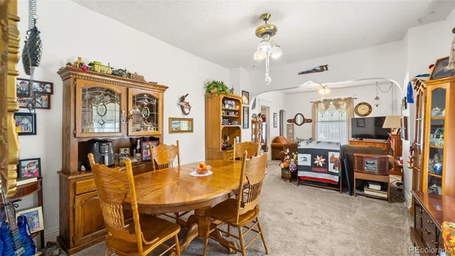 a view of a dining room with furniture and chandelier