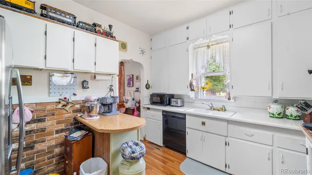 a kitchen with kitchen island a sink a stove and a window