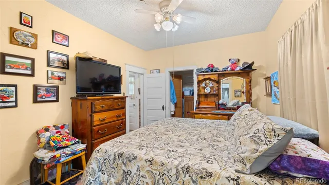 a bedroom with furniture and a flat screen tv