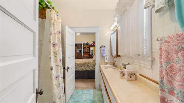 a bathroom with a tub sink and mirror