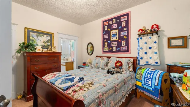 a bedroom with a bed and a dresser in it