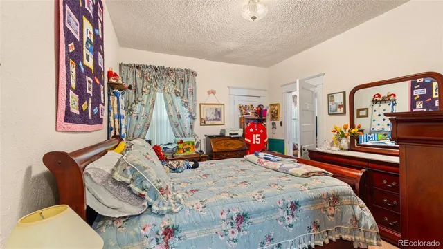 a bedroom with bed and a mirror