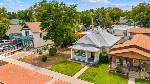 an aerial view of a house with swimming pool and a yard