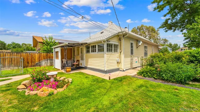 a view of a house with a yard and sitting area