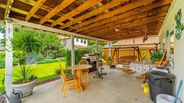 a view of a patio with table and chairs potted plants with swimming pool