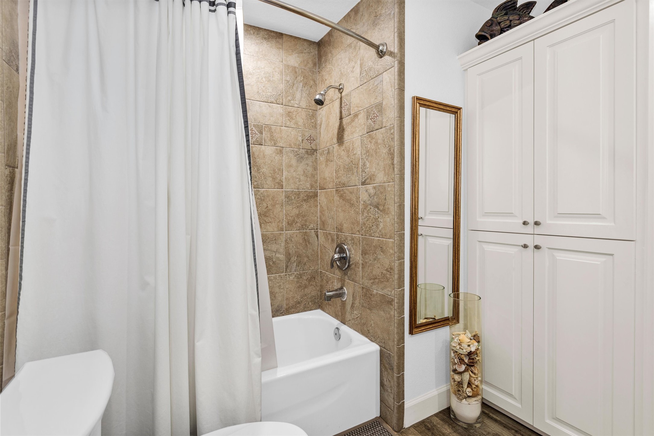 4402 Spears Road Manvel, TX 77578 - Photo 26 of 38 a bathroom with a shower curtain and a sink