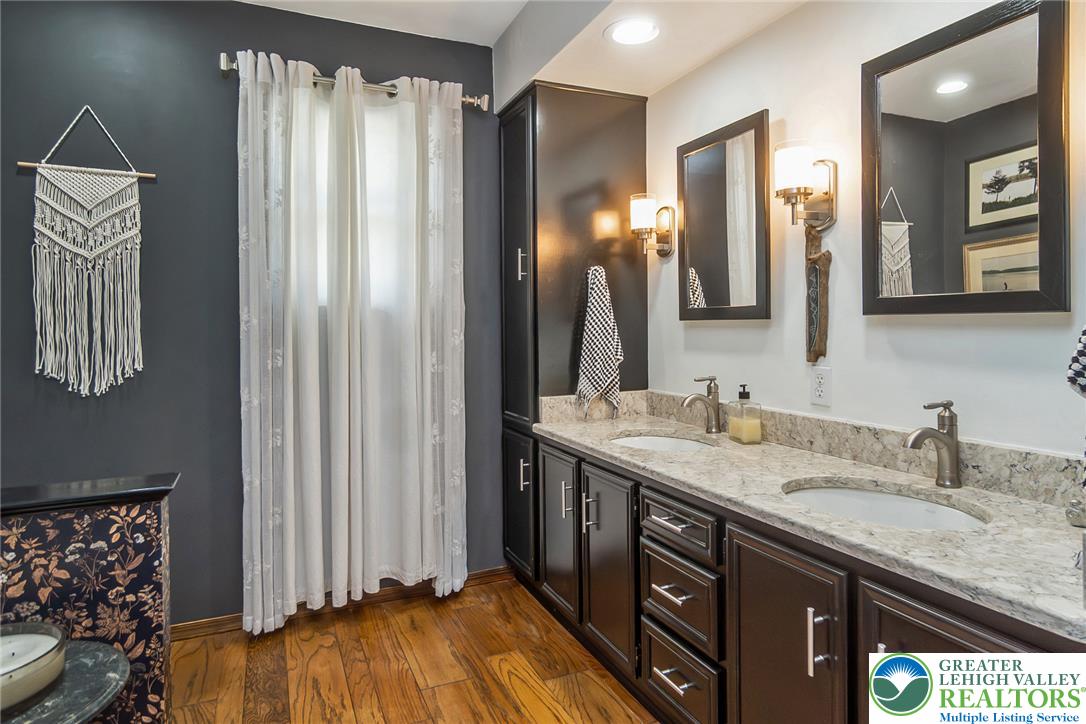 540 Briar Road Pen Argyl, PA 18072 - Photo 36 of 66 Double vanities with sleek cabinetry and a rich granite countertop create a refined and practical bathroom space.