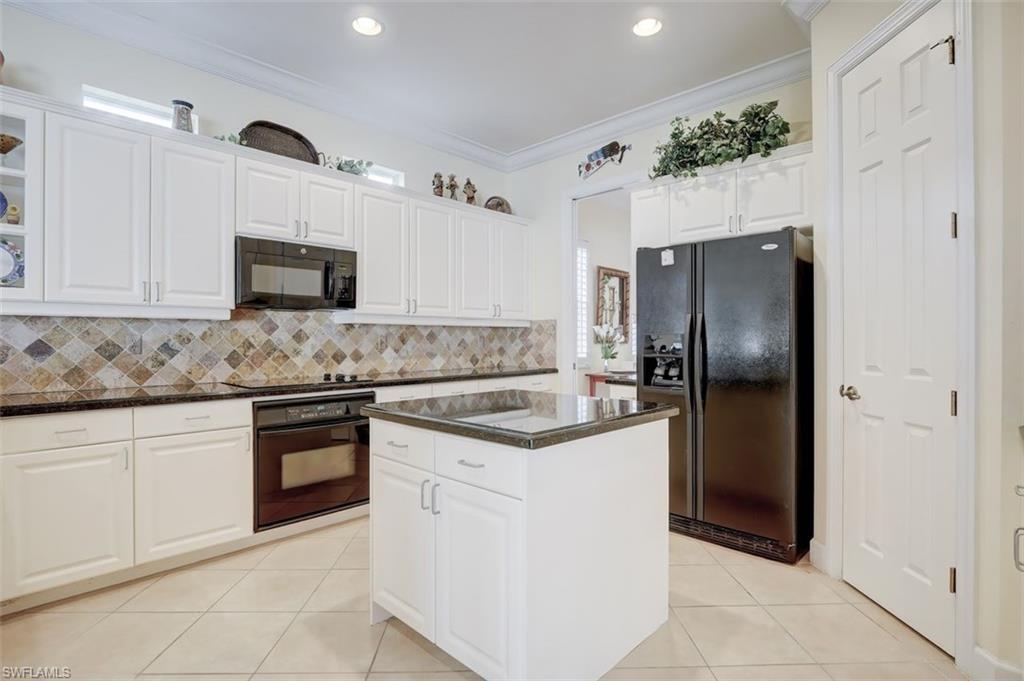 16092 Parque Lane Naples, FL 34110 - Photo 11 of 35 a kitchen with stainless steel appliances granite countertop a refrigerator and a stove